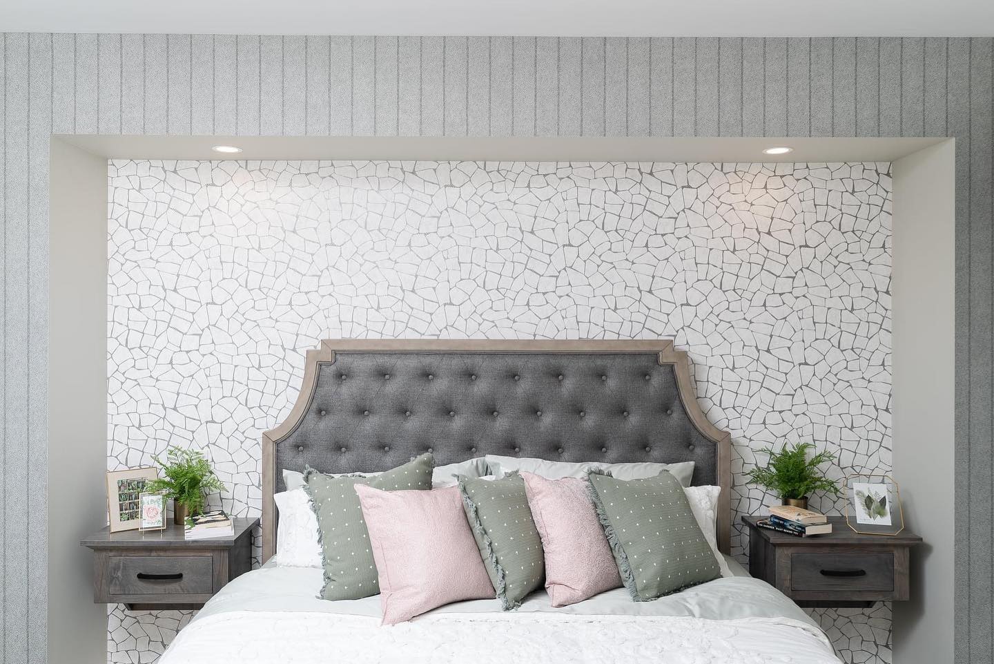This bedroom is a great example of combining different textures to give you a cozy look and feel to your bedroom. It combines design elements such as floating night tables, two wallpapers, and a headboard with both wood and fabric to add conversational elements to your primary bedroom.