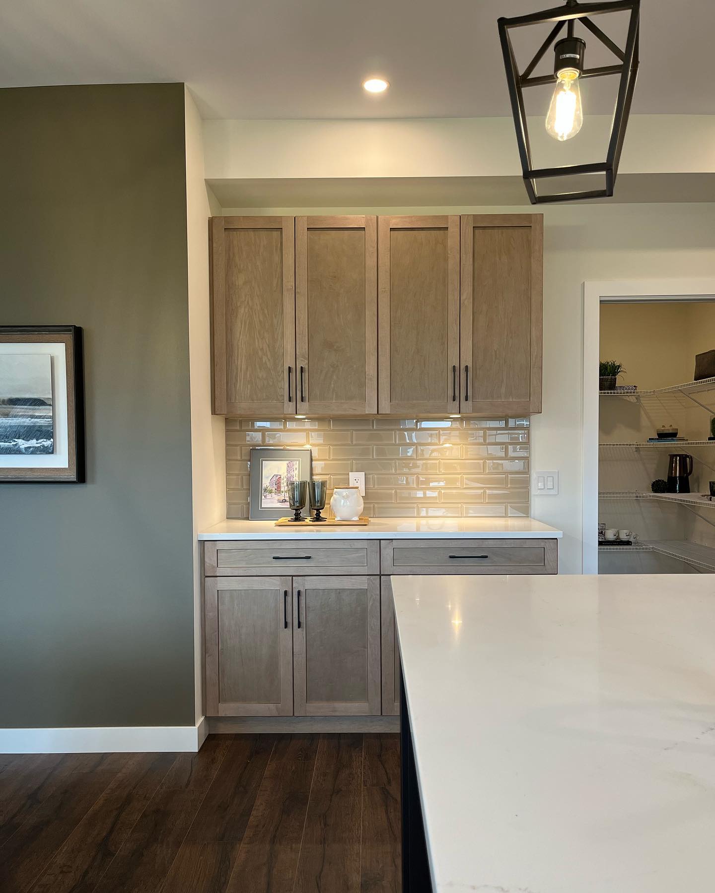We love kitchens with a coffee bar feature! 

The cool toned ceramic tile backsplash compliments the cabinetry just right. You’ll be able to tour through our brand new show home very soon! Stay tuned and visit our website for more information.